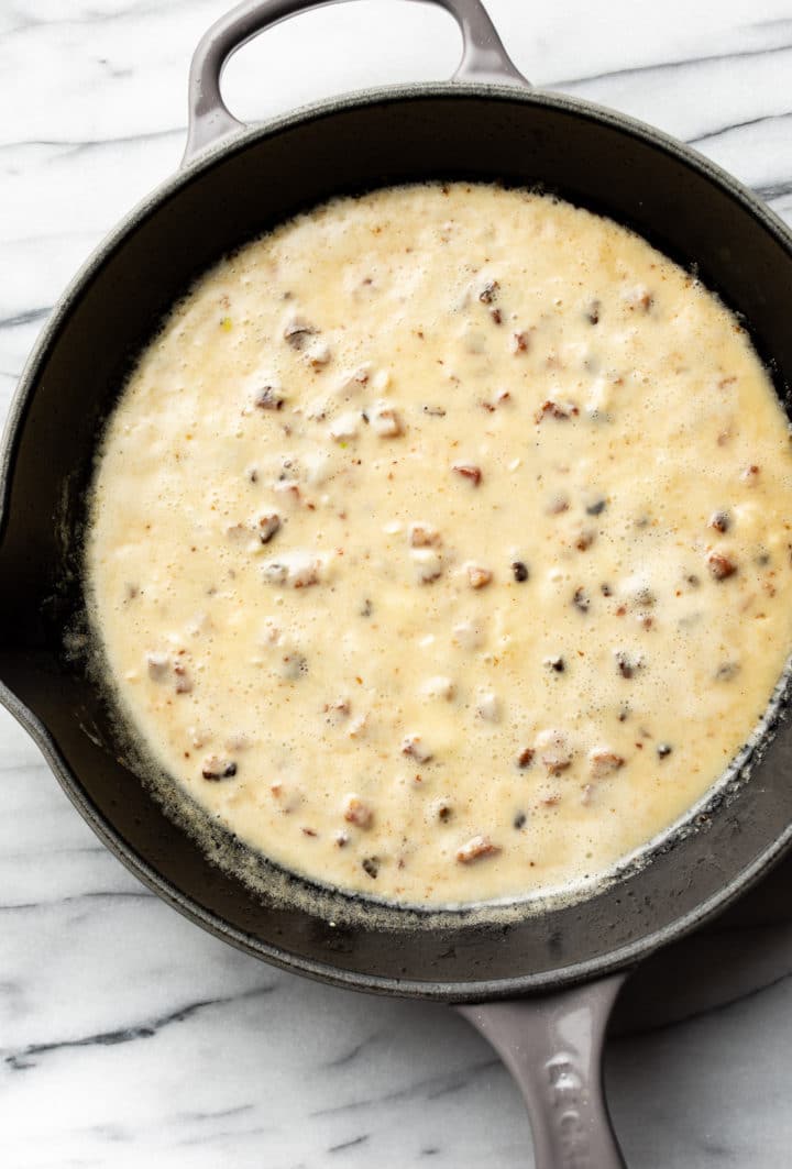 brie sauce with pancetta in a skillet