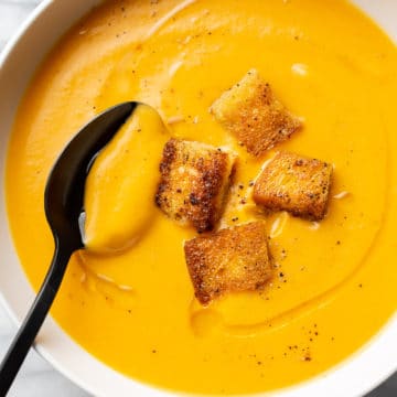 close-up of sweet potato soup in a white bowl