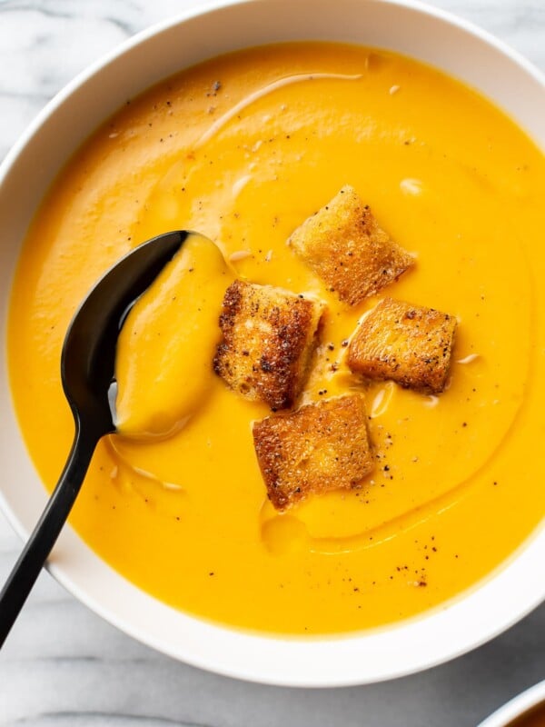 close-up of sweet potato soup in a white bowl