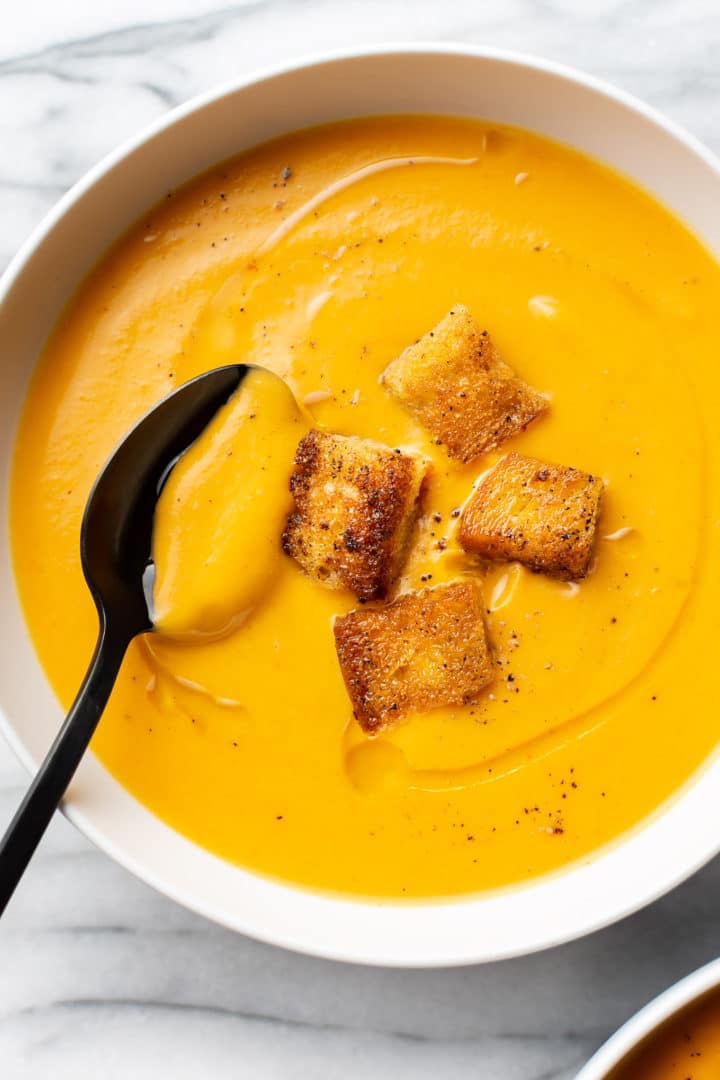 close-up of sweet potato soup in a white bowl