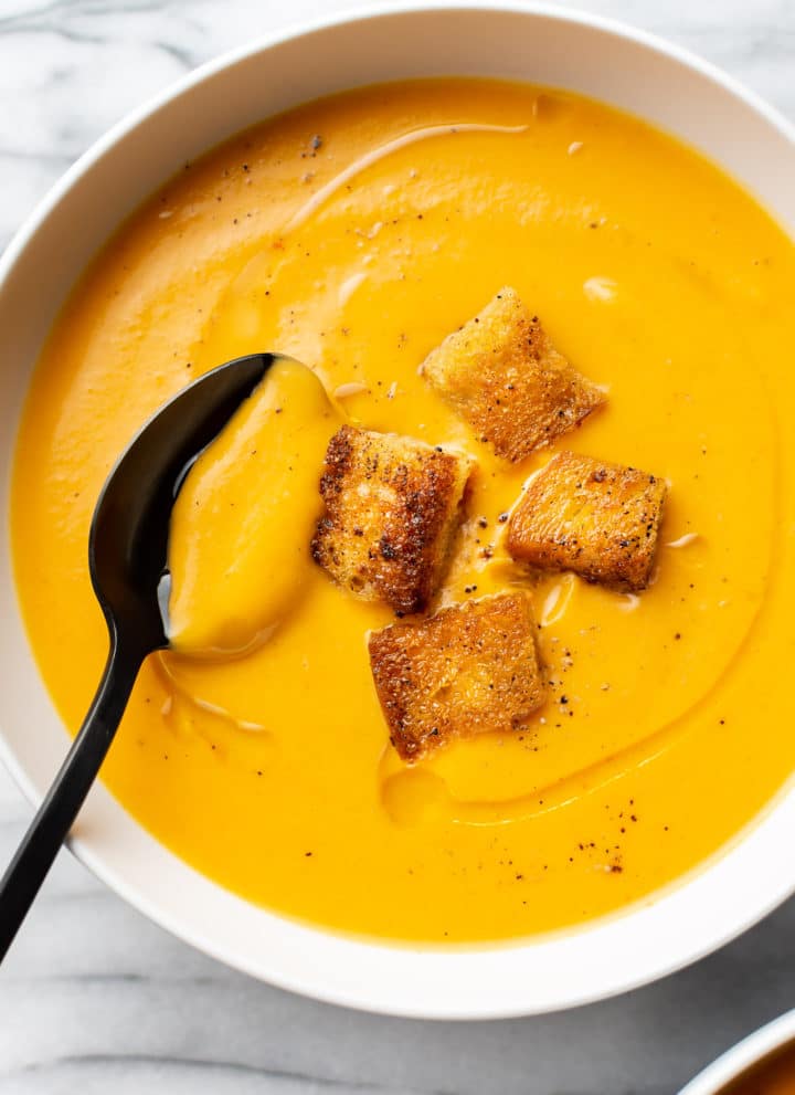 close-up of sweet potato soup in a white bowl
