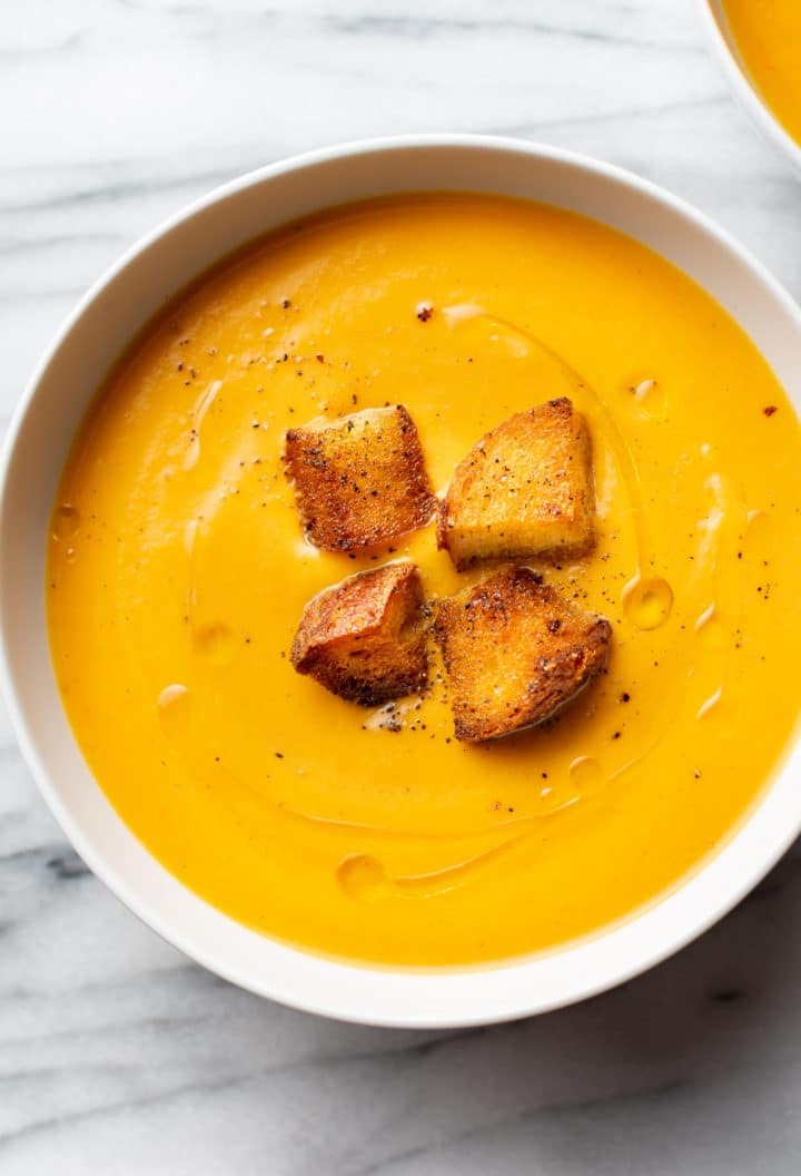 creamy sweet potato soup in a white bowl