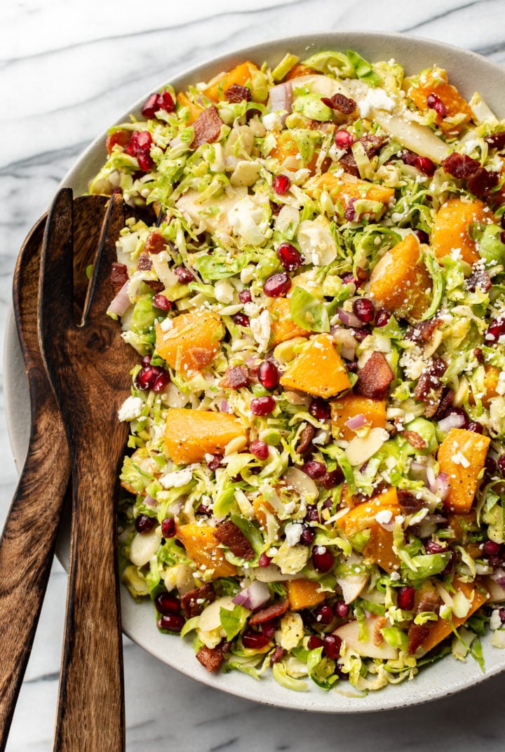 Thanksgiving salad in a salad bowl with wooden salad tongs