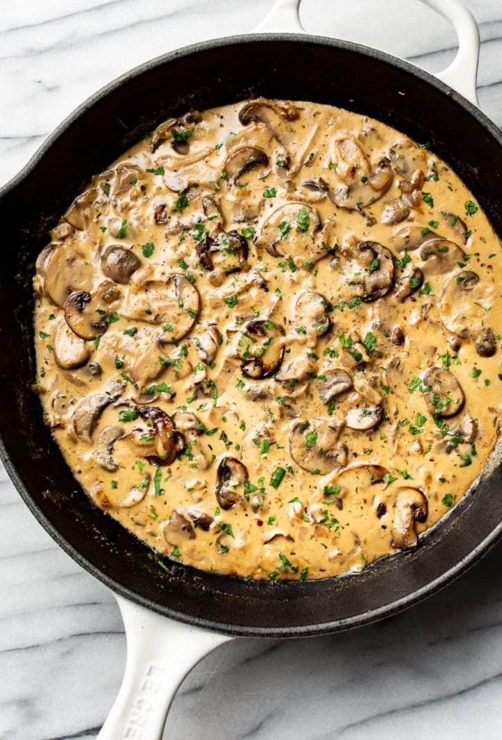 creamy mushroom sauce in a white skillet