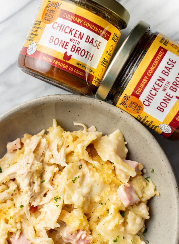 close-up of a bowl of Chicken Cordon Bleu Casserole next to two jars of Zoup concentrate