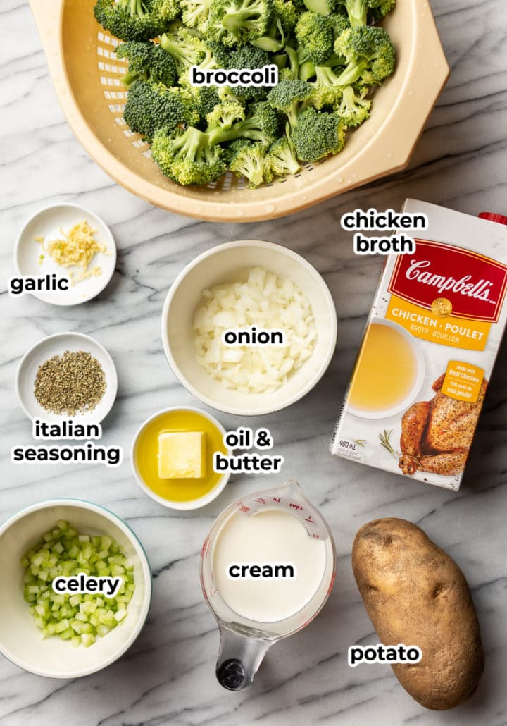 several bowls on a counter with ingredients for making cream of broccoli soup