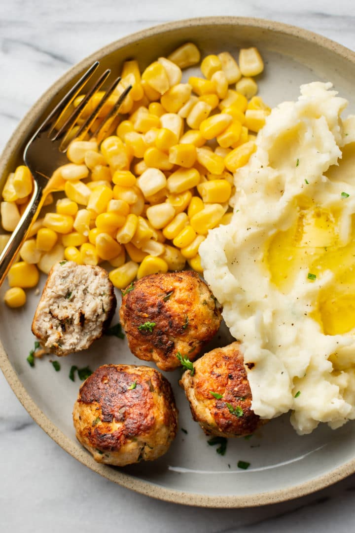 easy turkey meatballs, corn, and mashed potatoes on a plate with a fork
