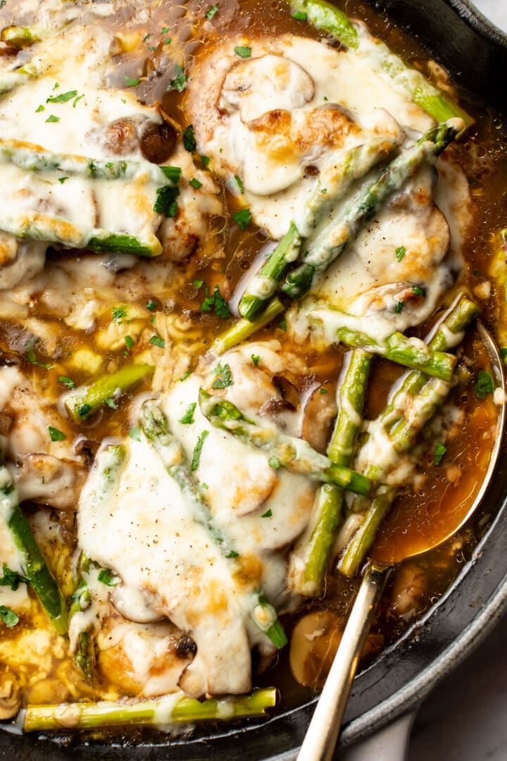 close-up of a skillet with chicken madeira and a serving spoon