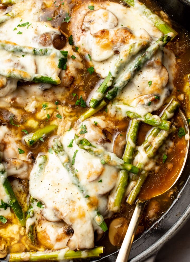 close-up of a skillet with chicken madeira and a serving spoon