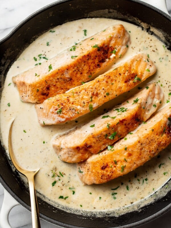 a cast iron skillet with creamy garlic salmon