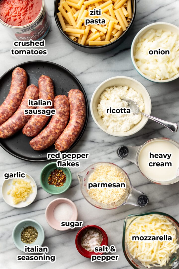 ingredients laid out on a marble surface to make baked ziti