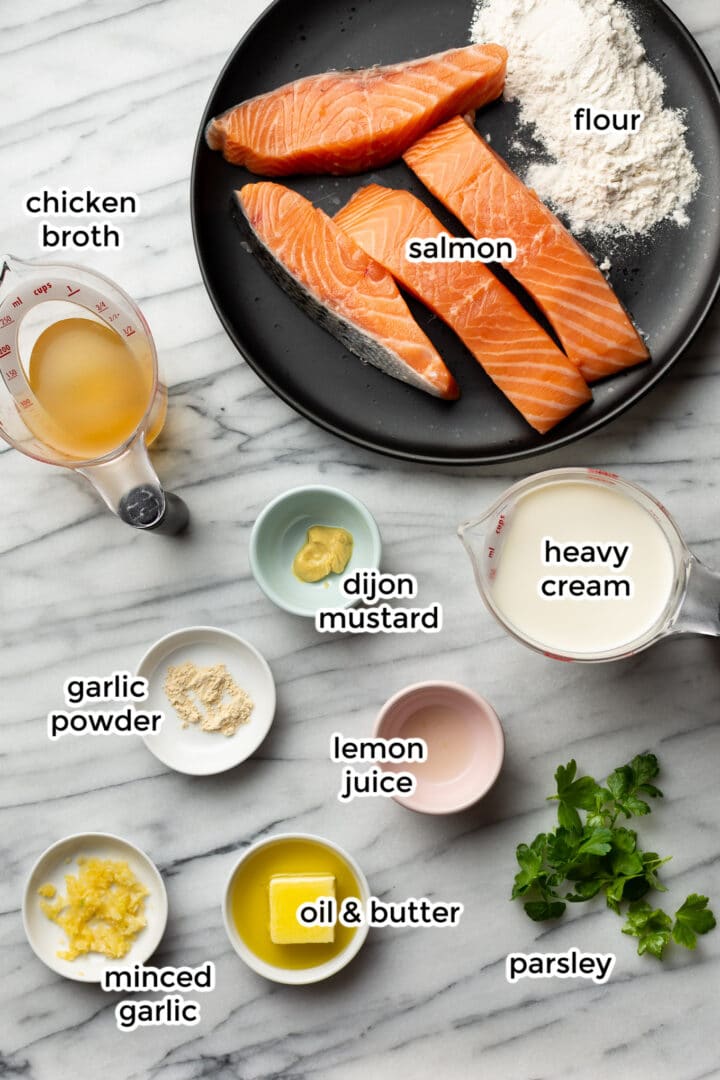 ingredients in small bowls on a marble surface to make creamy garlic salmon