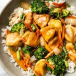 a bowl of chicken stir fry over rice