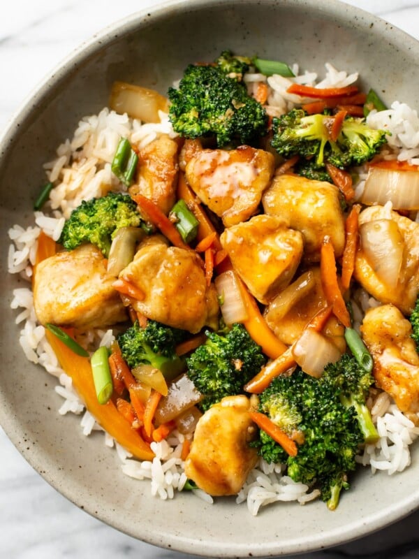 a bowl of chicken stir fry over rice