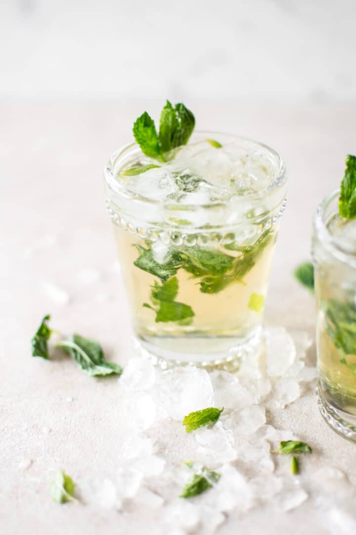 a mint julep next to crushed ice