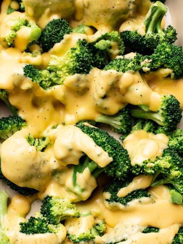 closeup of broccoli florets with cheese sauce