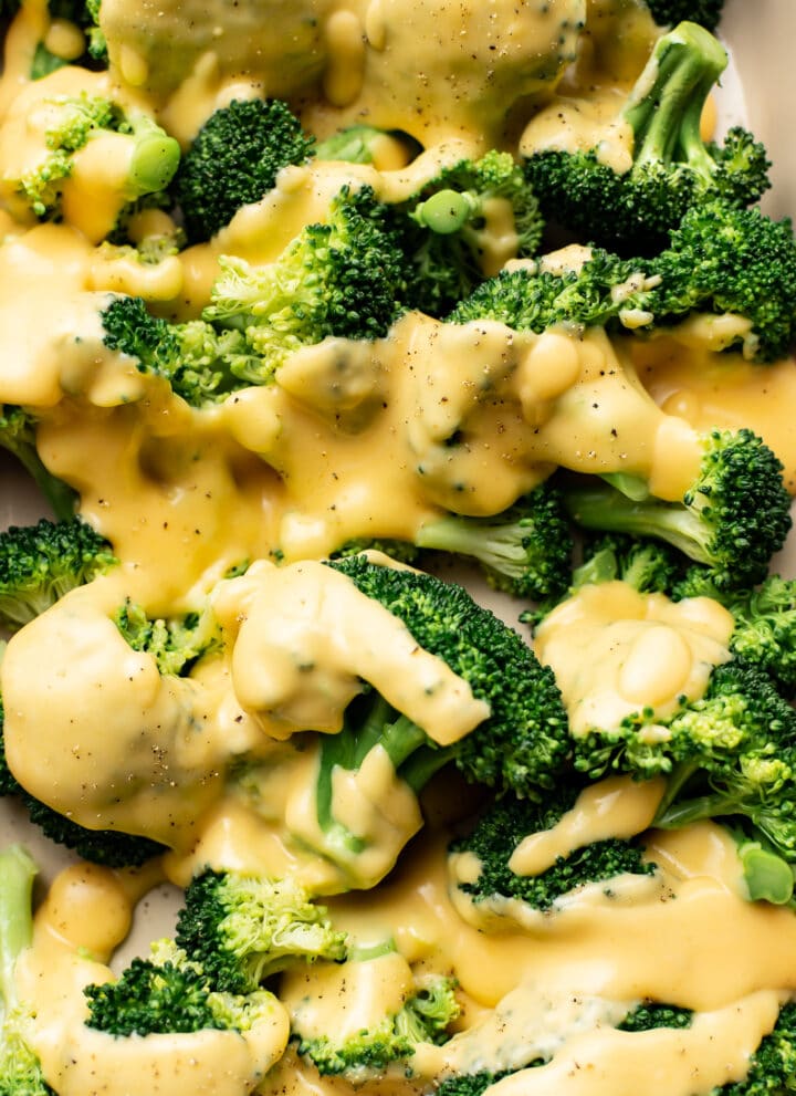 closeup of broccoli florets with cheese sauce