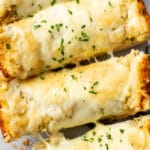 closeup of four slices of cheesy garlic bread