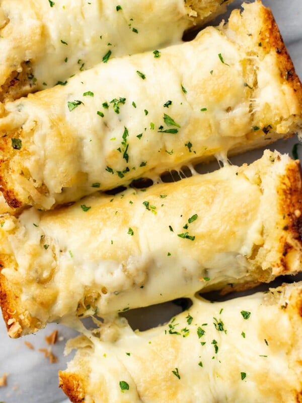 closeup of four slices of cheesy garlic bread