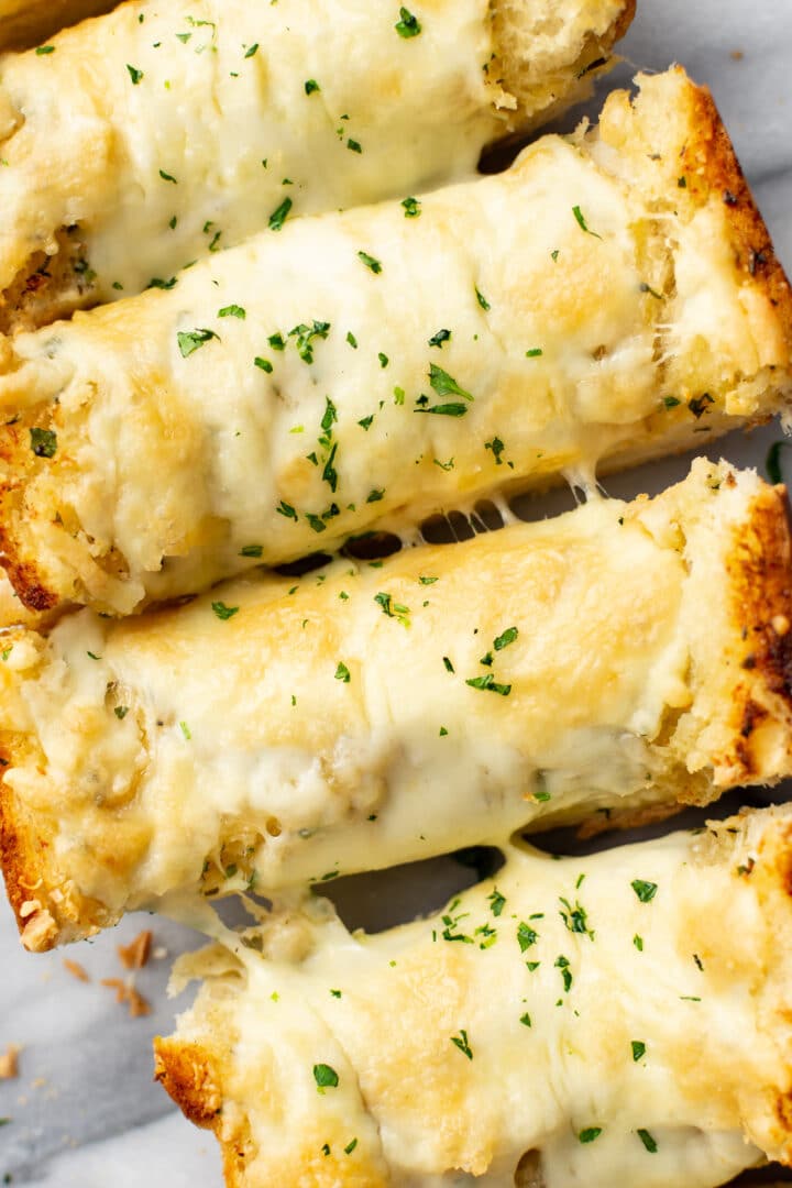 closeup of four slices of cheesy garlic bread