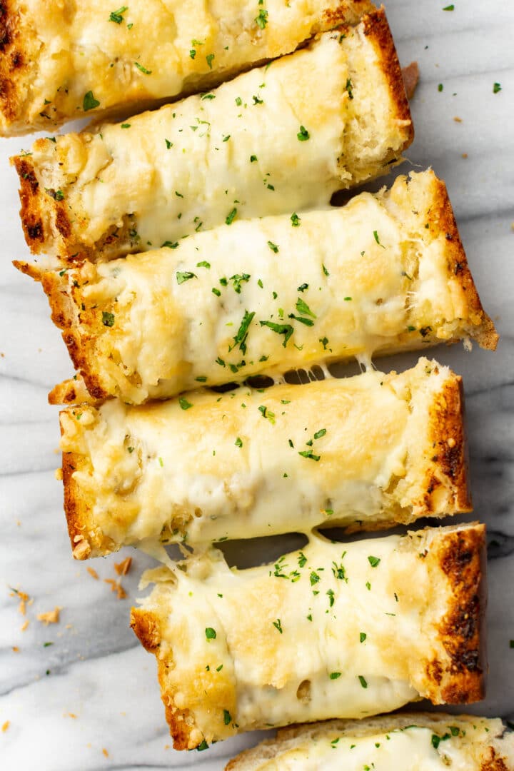 several slices of garlic bread on a marble surface