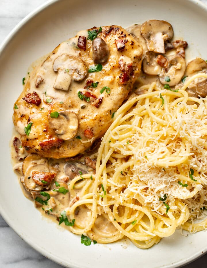 a plate with chicken riesling and buttered pasta