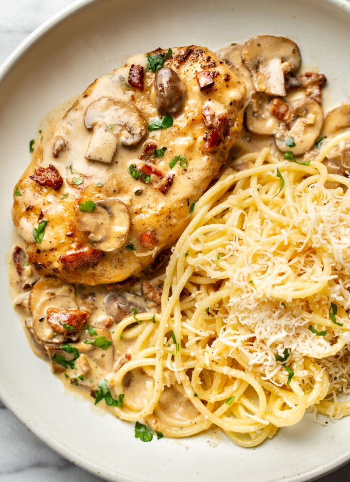 a plate with chicken riesling and buttered pasta