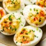 close up of several deviled eggs on a plate