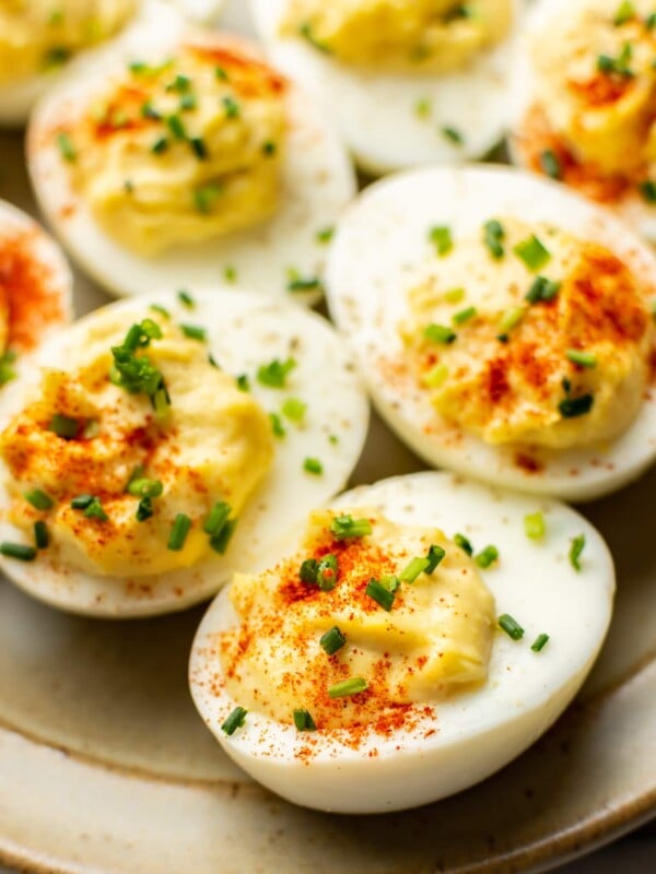 close up of several deviled eggs on a plate