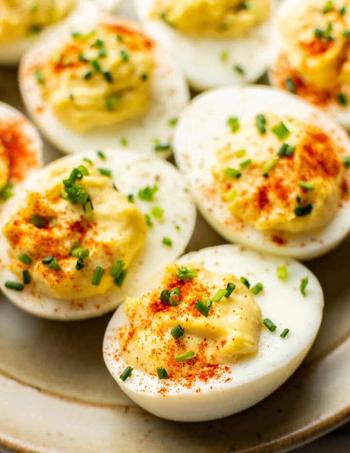 close up of several deviled eggs on a plate