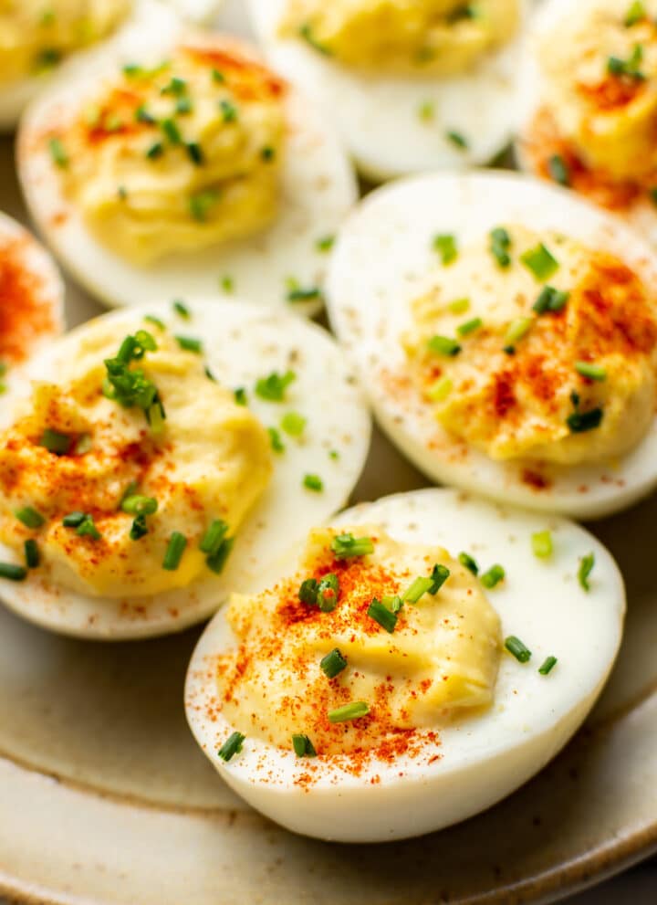 close up of several deviled eggs on a plate