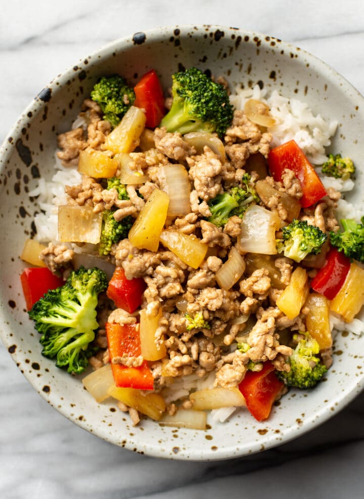 a bowl of ground pork stir fry over rice