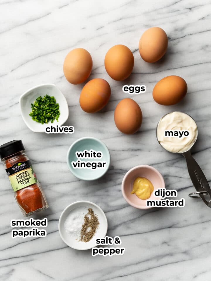 ingredients for deviled eggs on a marble surface