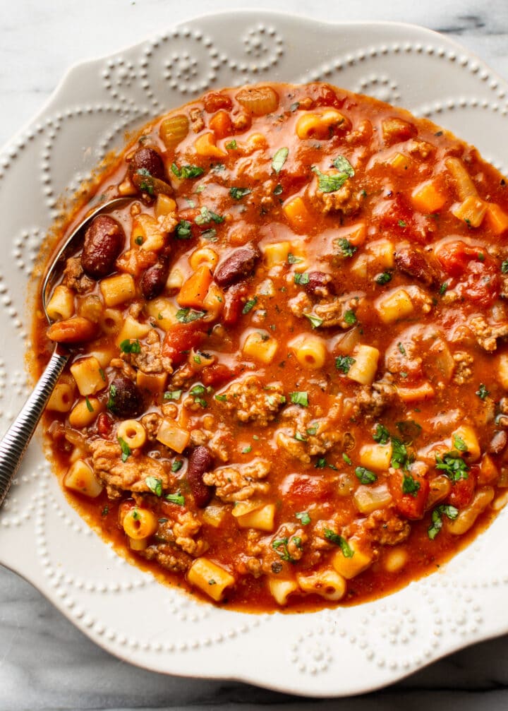 a bowl of pasta e fagioli with a spoon