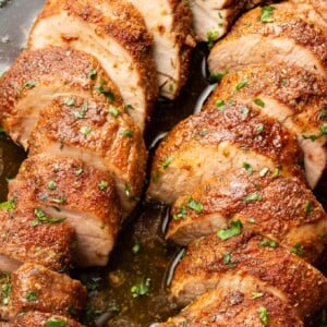 closeup of a plate with baked pork tenderloin slices