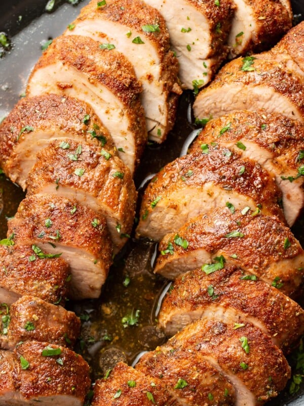 closeup of a plate with baked pork tenderloin slices