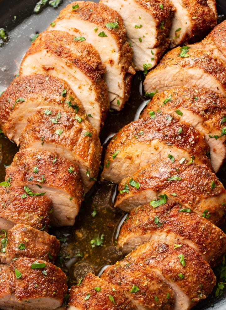 closeup of a plate with baked pork tenderloin slices