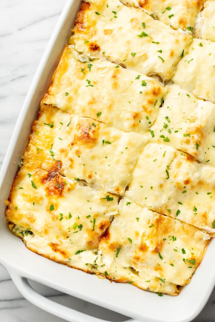 a baking dish with cheesy chicken lasagna