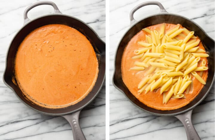 adding penne pasta to vodka sauce in a cast iron skillet