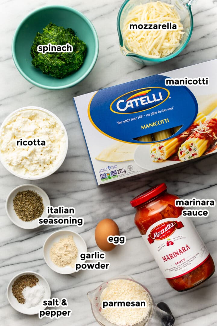 ingredients for manicotti on a counter in small bowls