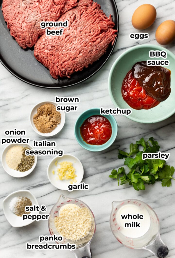 ingredients for meatloaf in bowls on a marble surface