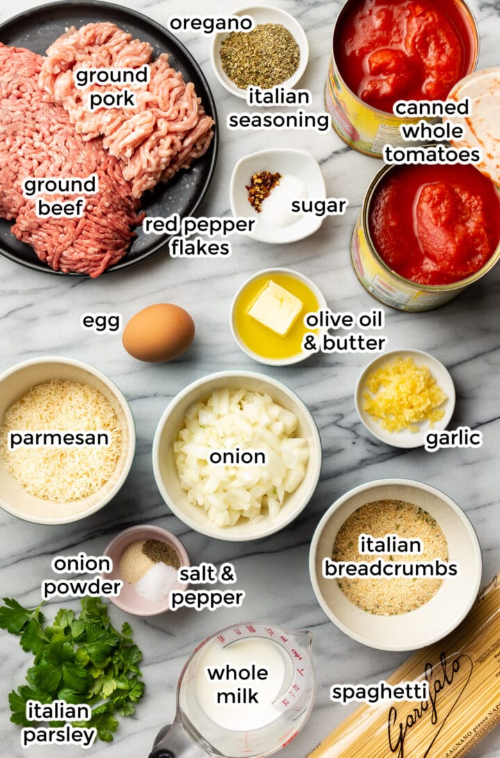 ingredients for spaghetti and meatballs on a marble surface