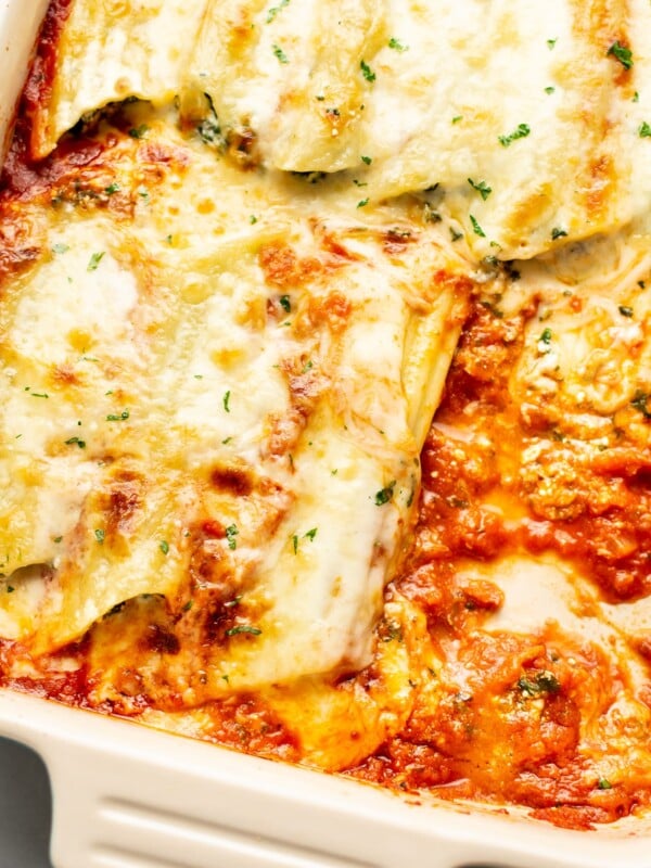 closeup of a baking dish with cheesy manicotti