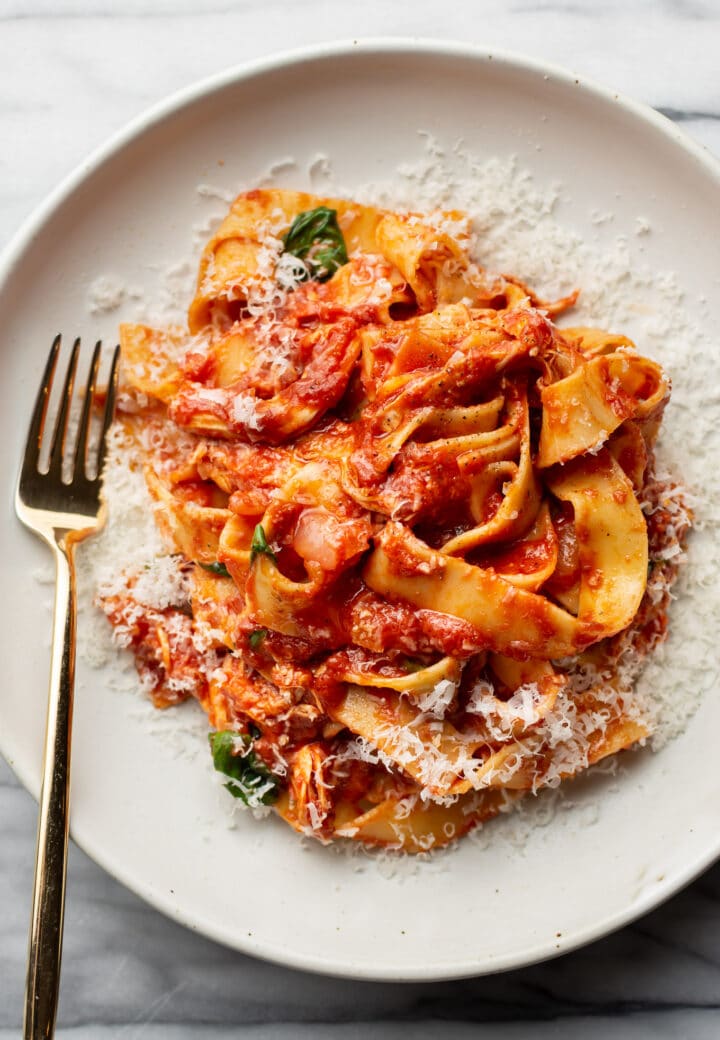 a bowl of chicken arrabiata pasta with a fork