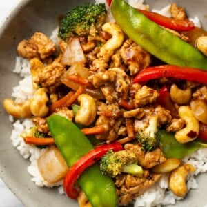 a bowl of ground chicken stir fry over jasmine rice