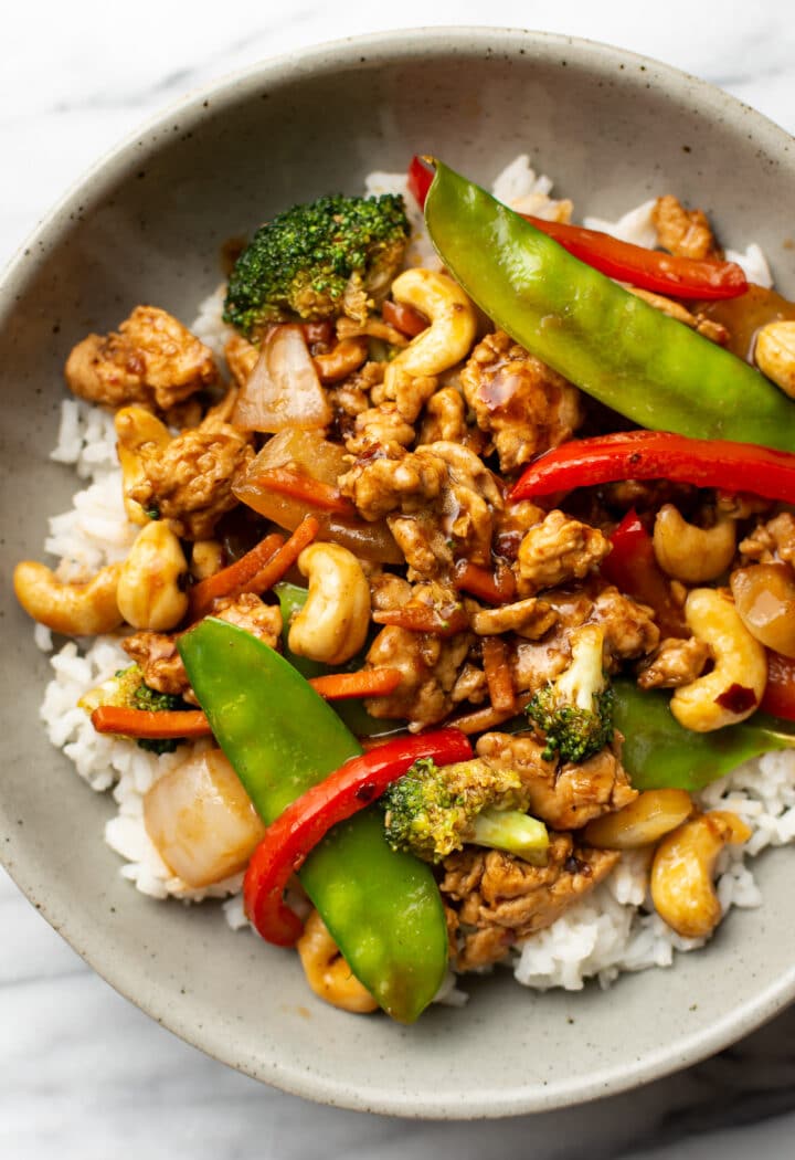 a bowl of ground chicken stir fry over jasmine rice