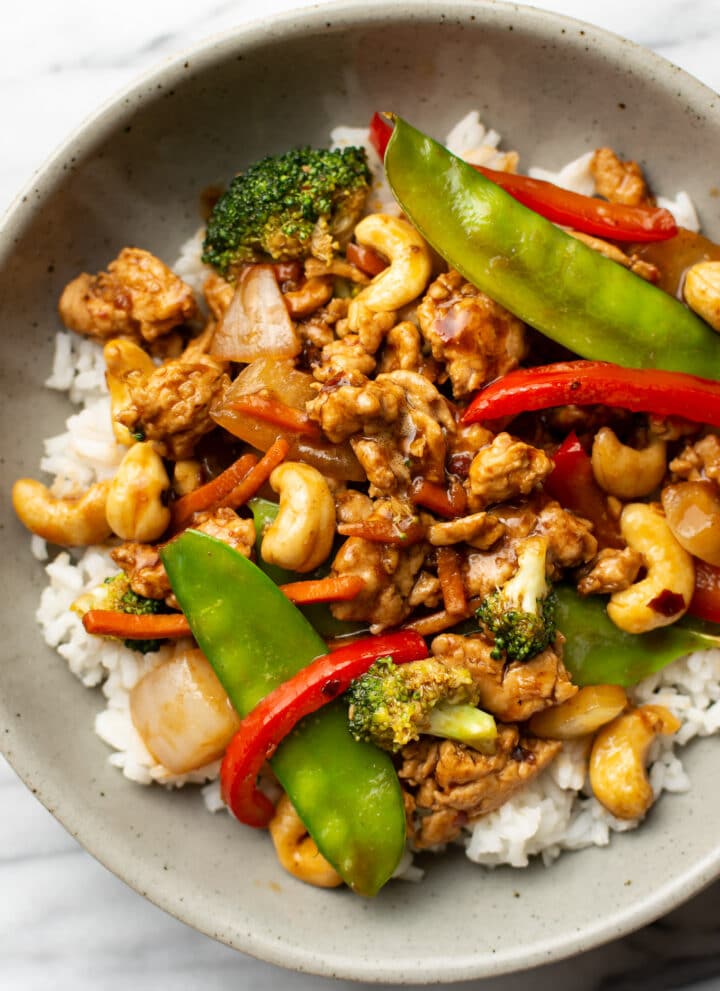 a bowl of ground chicken stir fry over jasmine rice
