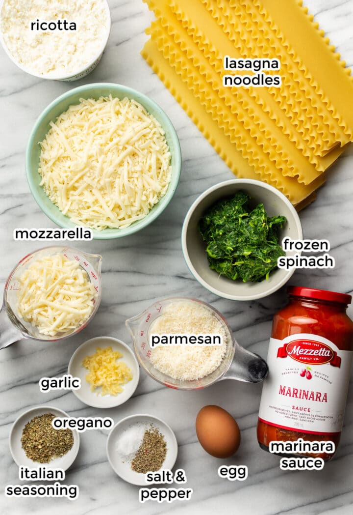 ingredients for lasagna roll ups in small bowls on a counter