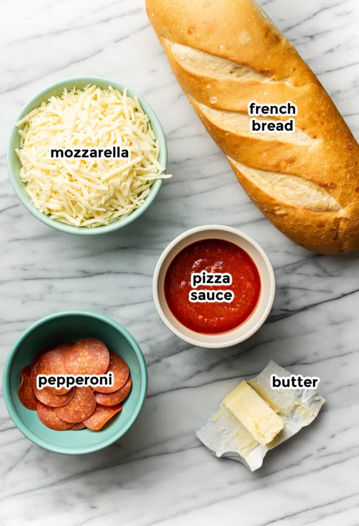 ingredients for french bread pizza on a counter