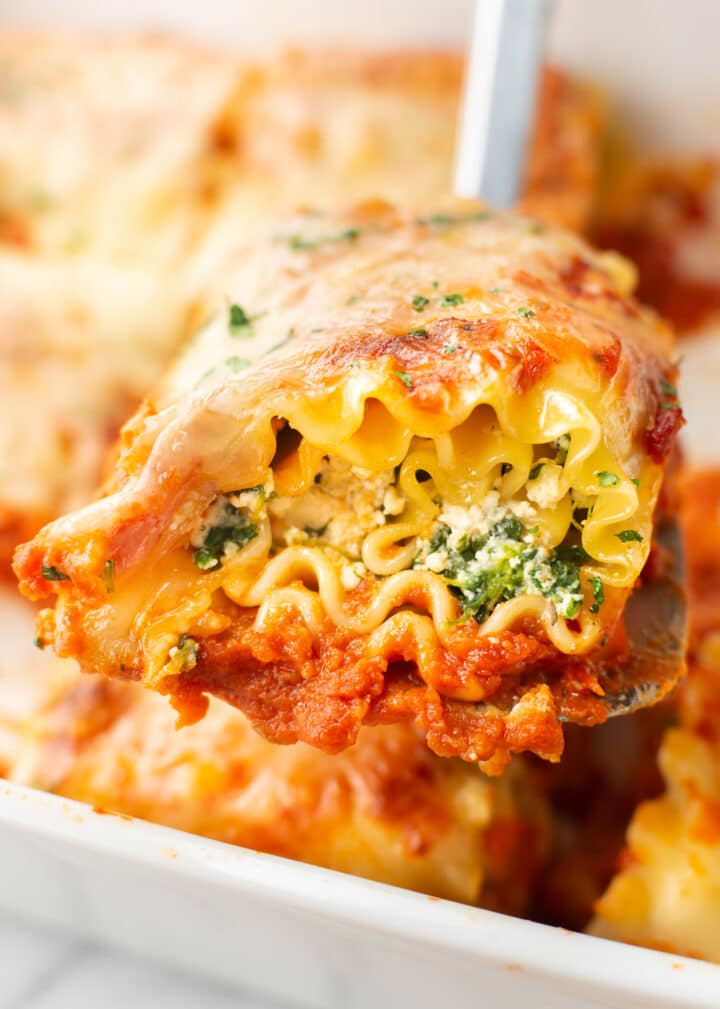 a spatula with a portion of lasagna rollups